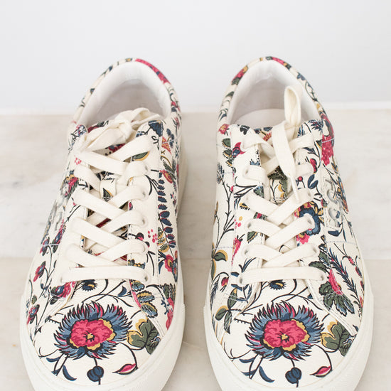 Pair of floral-patterned sneakers on a light background