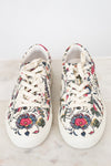 Pair of floral-patterned sneakers on a light background