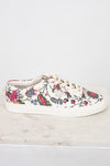 Floral-patterned sneaker on a white marble surface