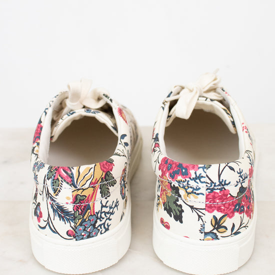Pair of floral-patterned sneakers on a white background