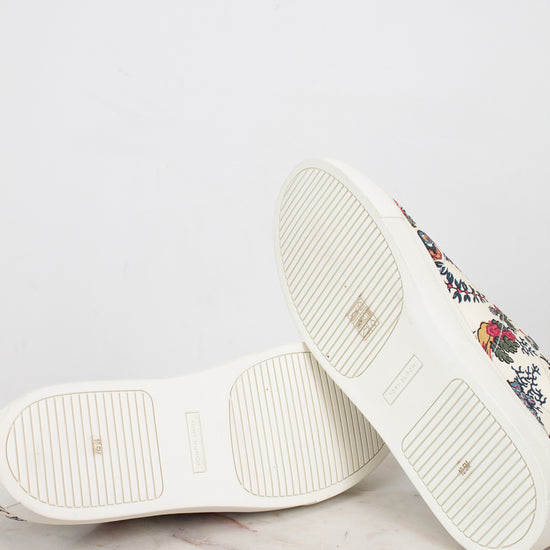 White sneakers with floral pattern on a light gray background