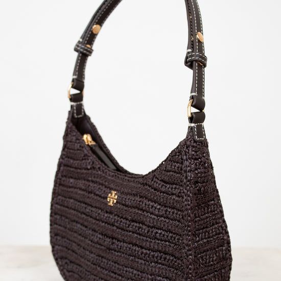 Brown textured handbag with gold accents on a light gray background