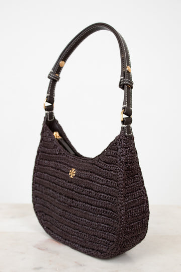 Brown textured handbag with gold accents on a light gray background