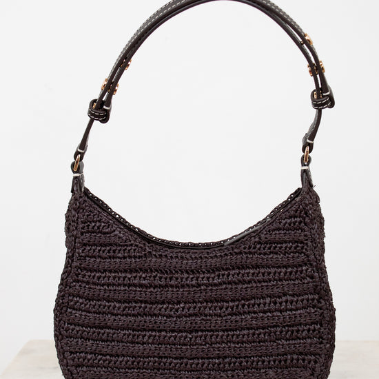 Brown crochet handbag with brown handle on a white background
