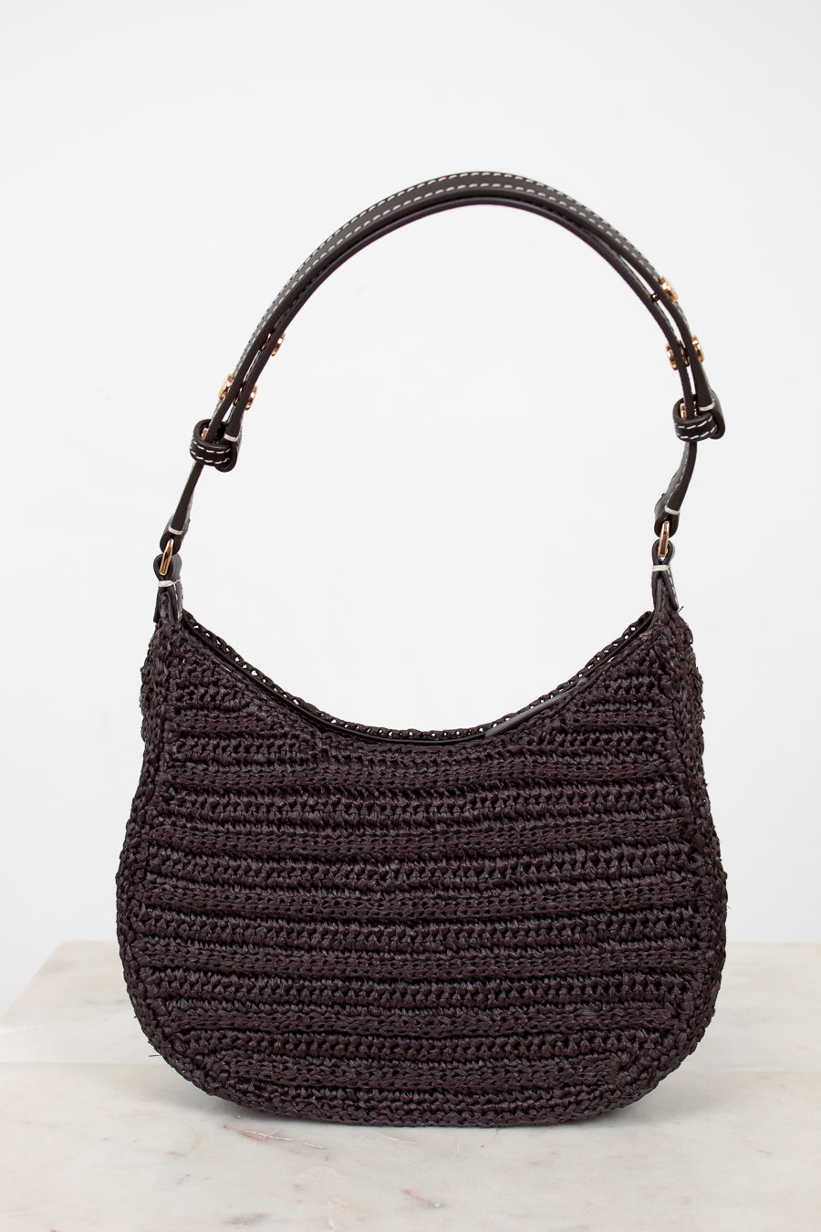 Brown crochet handbag with brown handle on a white background