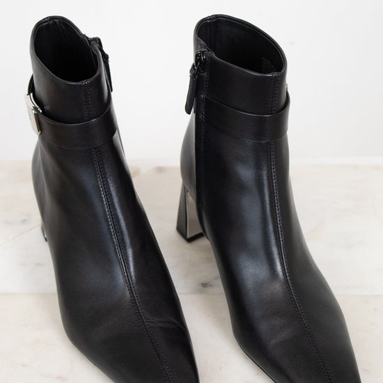 Black boot with squared pointed toe detail seen from an above view