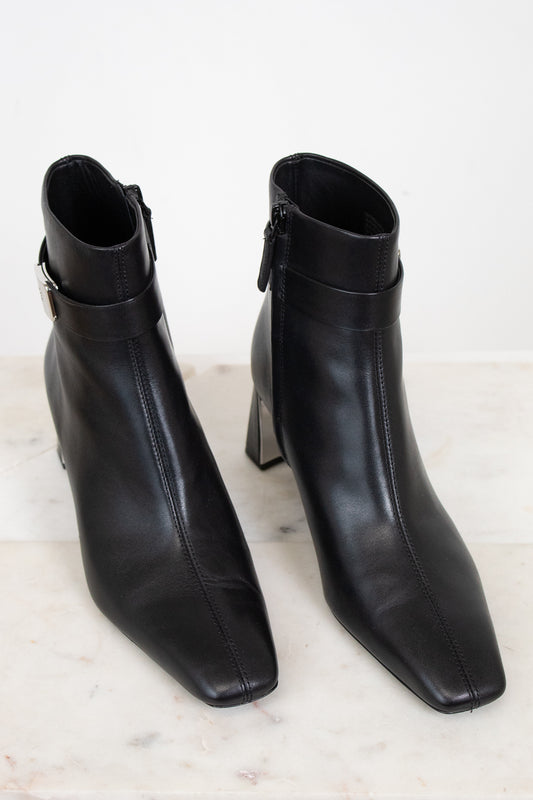 Black boot with squared pointed toe detail seen from an above view