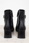 Back view of black leather ankle boots showing block heel and ankle strap detail