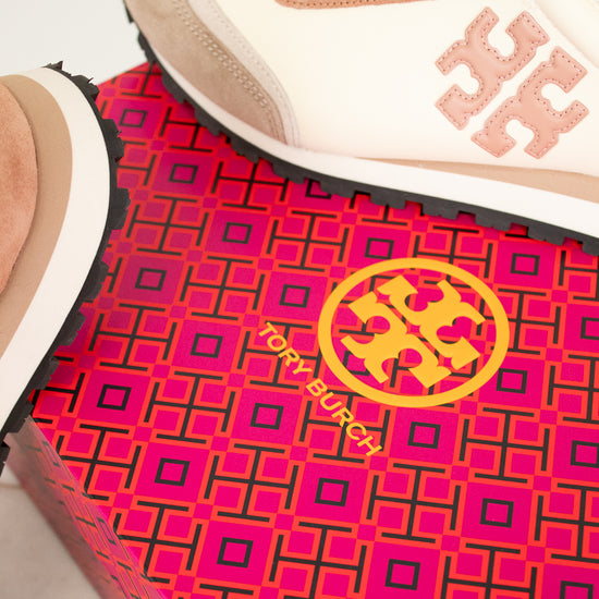 Tory Burch sneaker on a pink and black patterned mat