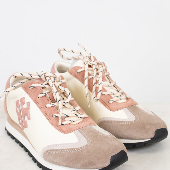 Pair of pink and beige sneakers on a white background