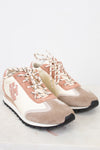 Pair of pink and beige sneakers on a white background