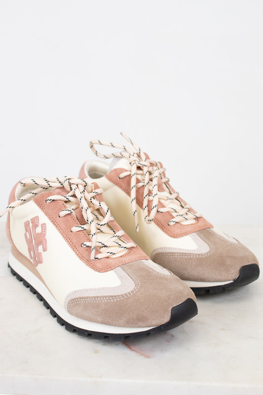 Pair of pink and beige sneakers on a white background