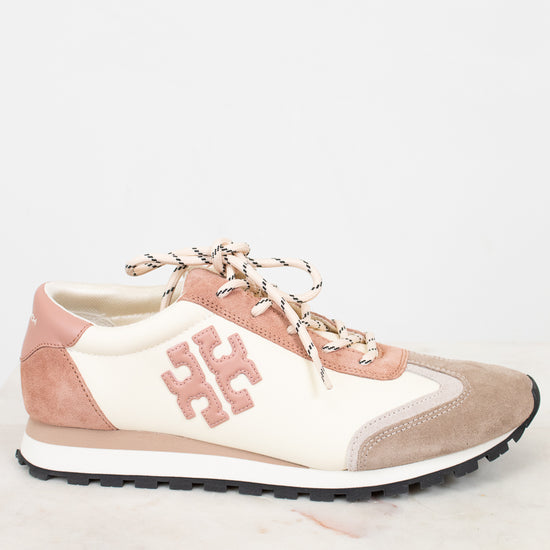 Pink and beige sneaker with a logo on a white background