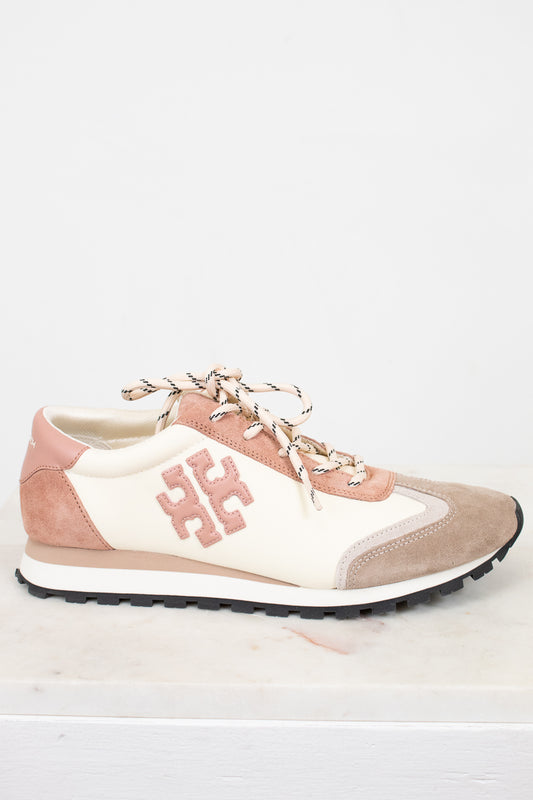 Pink and beige sneaker with a logo on a white background
