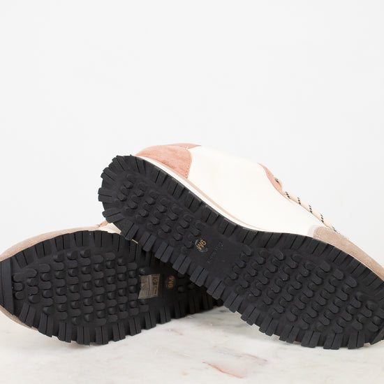 Close-up of a shoe sole with tread pattern on a light background
