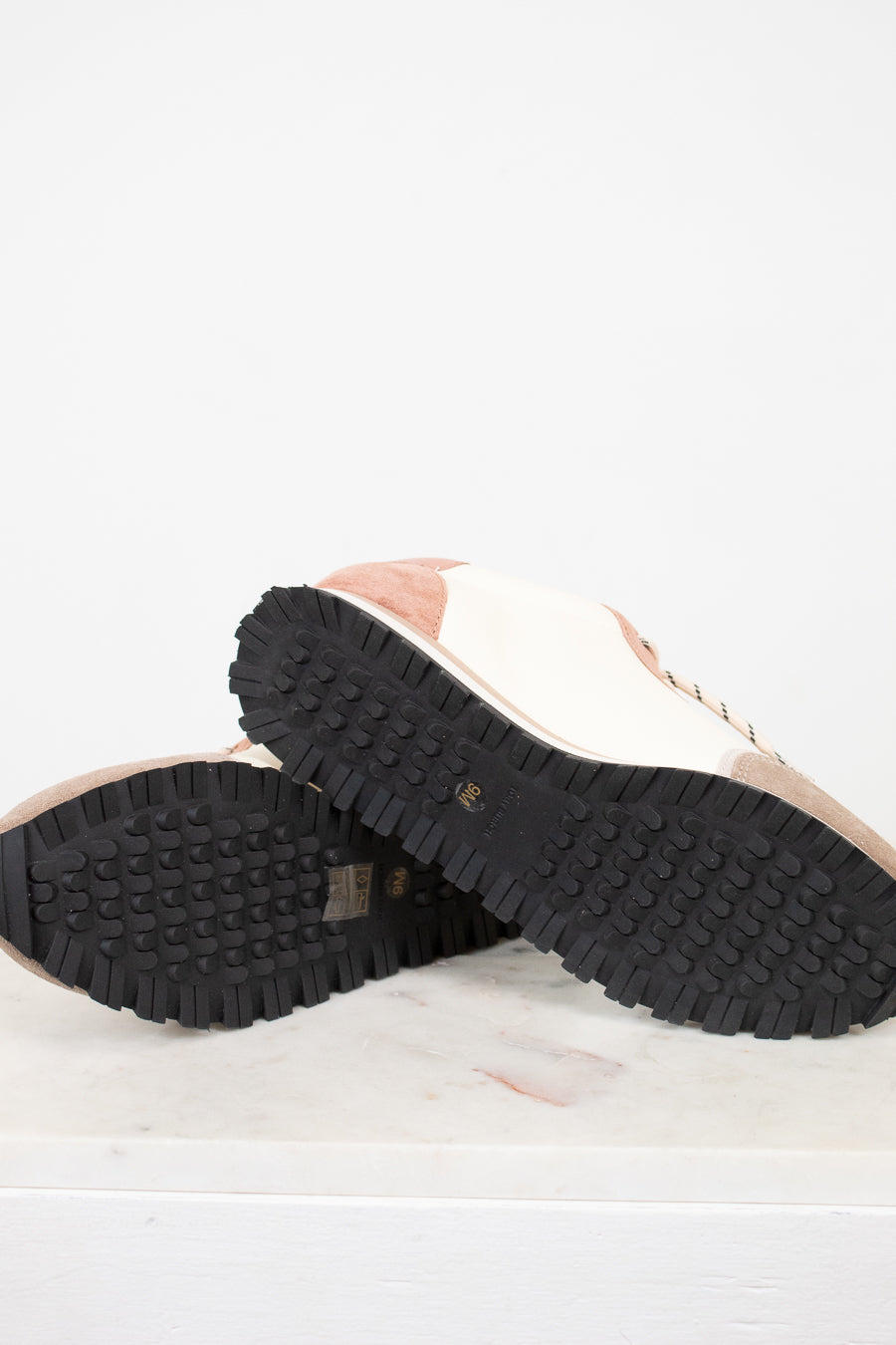 Close-up of a shoe sole with tread pattern on a light background