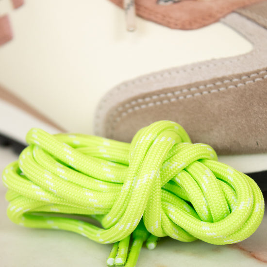 Close-up of green shoelaces on a sneaker with a blurred background