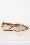 A single women's flat shoe with a beige and black snakeskin pattern and a gold-tone chain detail on the toe, shown on a white marble surface against a white background.