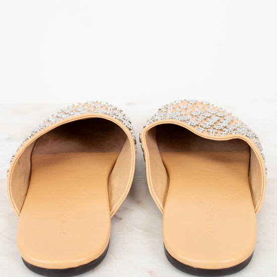 Pair of embellished slippers on a white background