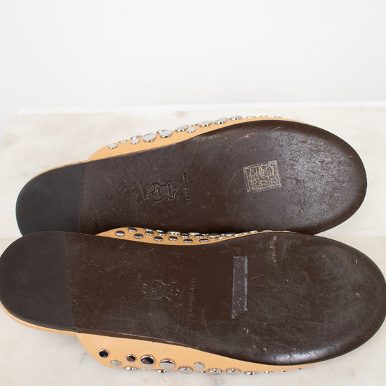 Close-up of the soles of a pair of shoes on a marble surface