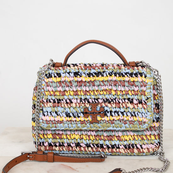 Multicolored woven handbag with a chain detail on a white background