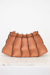 Brown leather handbag with drawstring on a white background