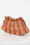 Tan leather handbag with drawstring on a light background