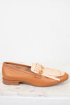 Tan loafer with beige tassel on a white background