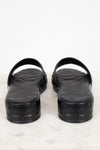 Black sandals with a Valentino brand logo on a white background