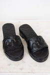 Pair of black slides on a light marble background