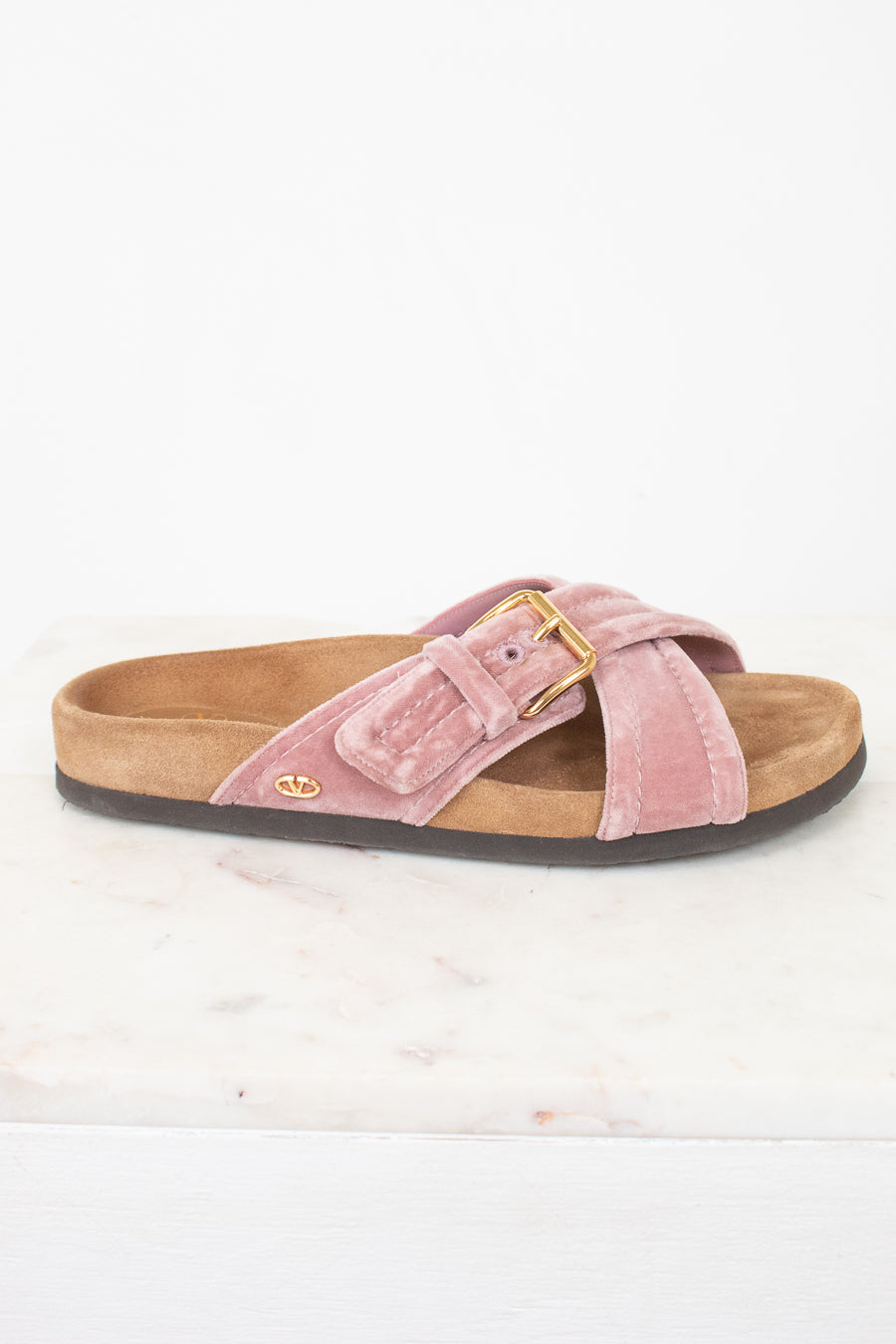 Side view of pink velvet with brown sole sandals
