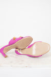 Pair of pink heeled sandals on a white background