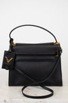 Black handbag with gold accents on a white background