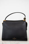 Black handbag with gold accents on a white background