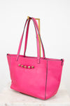 Pink tote bag with gold accents on a white background