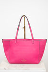 Pink handbag with a visible brand logo on a white background