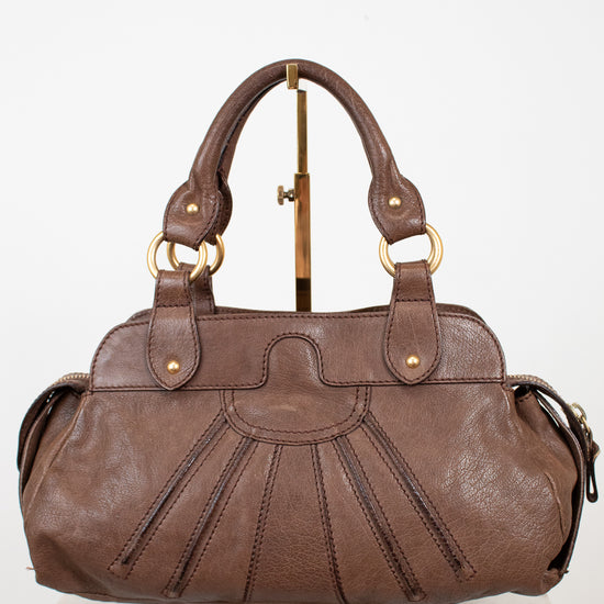 Brown leather handbag on a white background