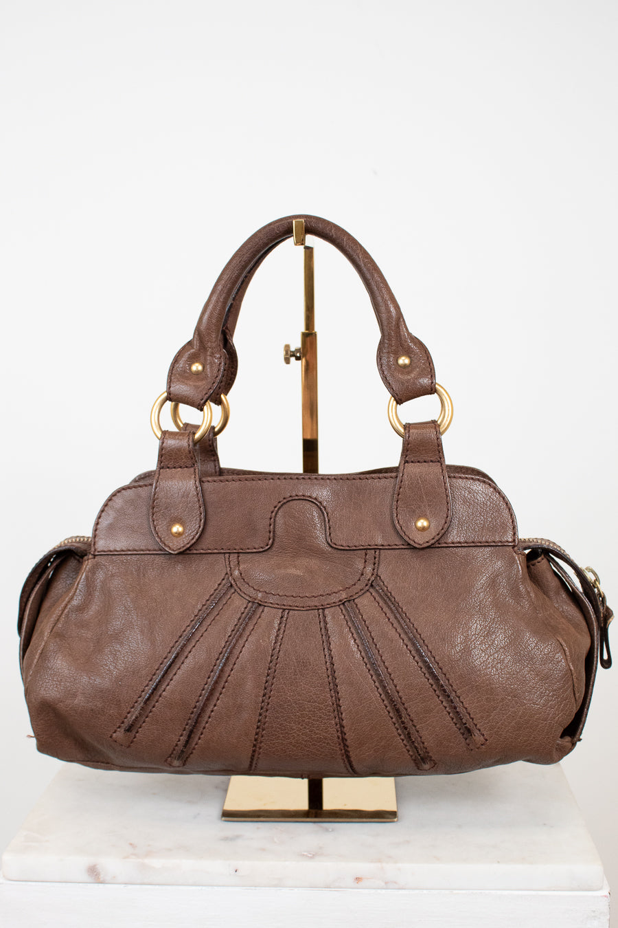 Brown leather handbag on a white background
