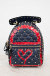 A small quilted backpack with navy blue and red details, gold-tone studs, and a red heart design on the front, photographed against a plain light background.