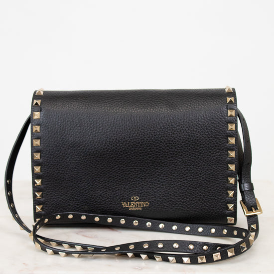 Black studded handbag with a visible brand logo on a white background