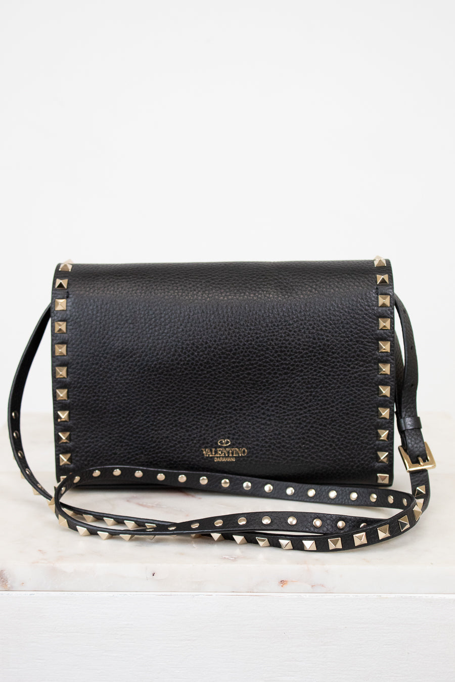 Black studded handbag with a visible brand logo on a white background