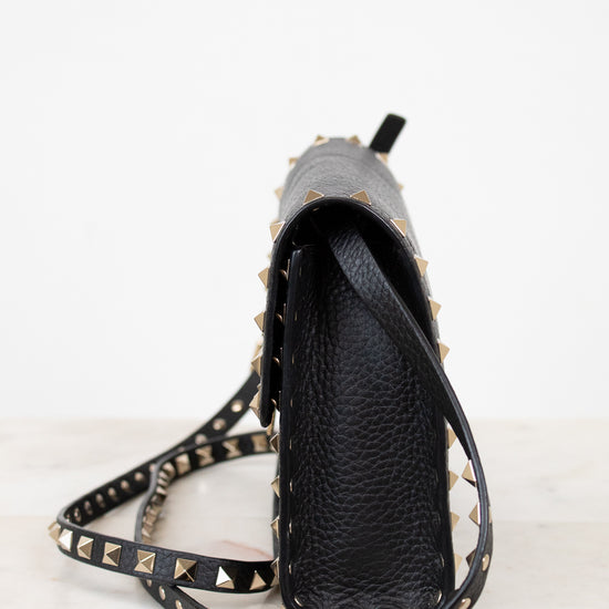 Black studded crossbody on a white background
