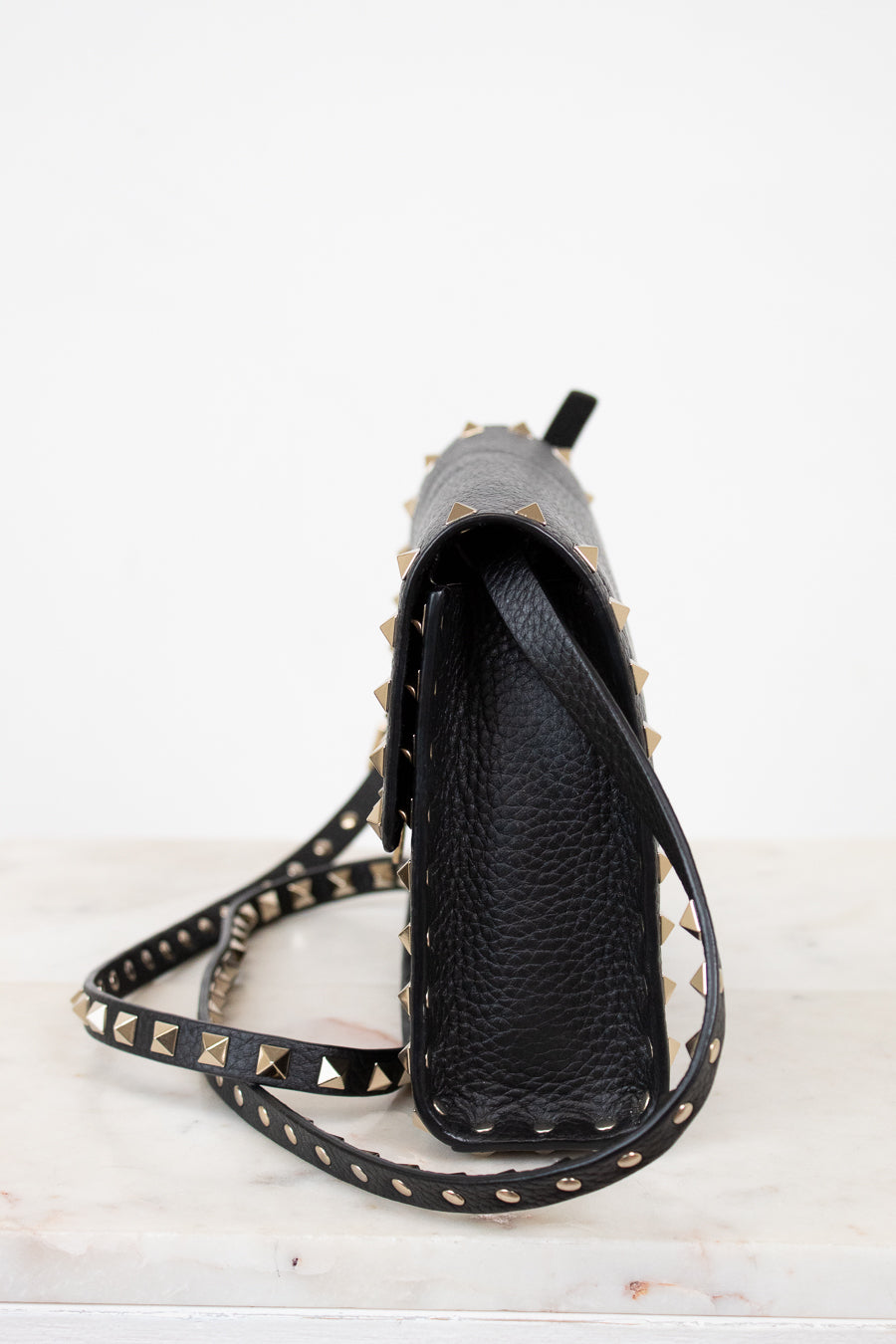 Black studded crossbody on a white background