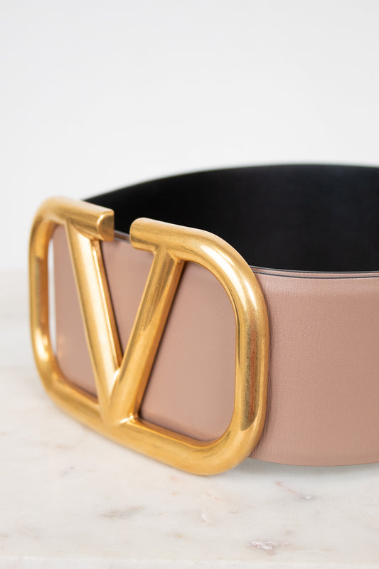 Beige belt with gold 'V' Logo buckle on a light background
