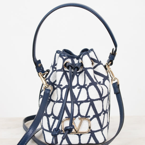 Designer handbag with blue and white pattern on a light background