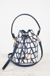 Designer handbag with blue and white pattern on a light background
