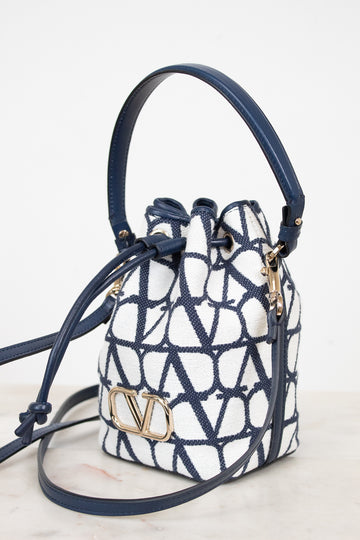 Designer handbag with geometric pattern and visible brand logo on a light background