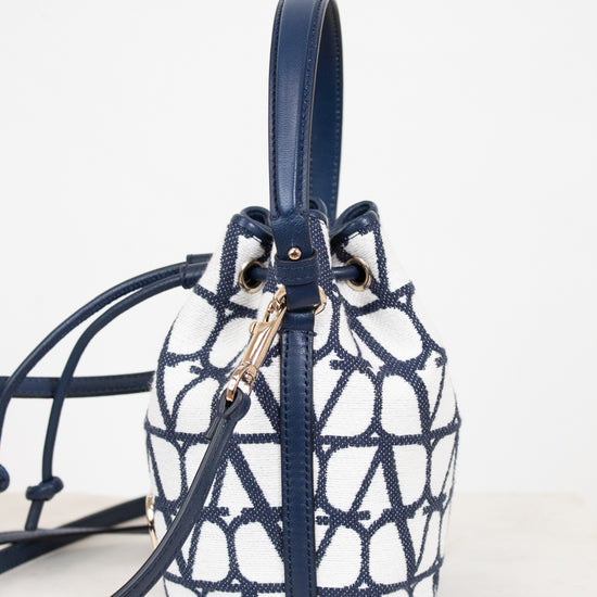Navy and white patterned handbag on a light background