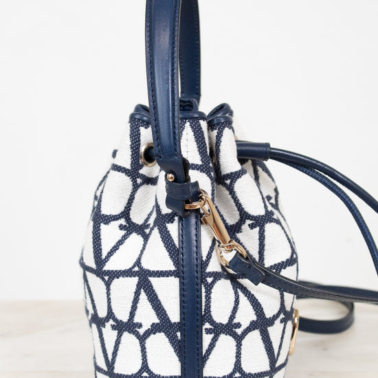 Navy and white patterned handbag on a light background