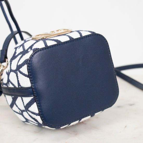Navy blue and white patterned handbag on a light marble surface
